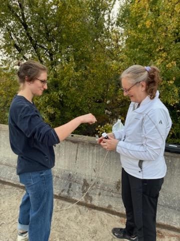 Area residents Renny & Jana Klein, Iowa Women for Water volunteers, collect water from Abbe Creek. The samples are tested for nitrates and other pollutants and data is posted on the Izaak Walton League’s Save Our Streams site.