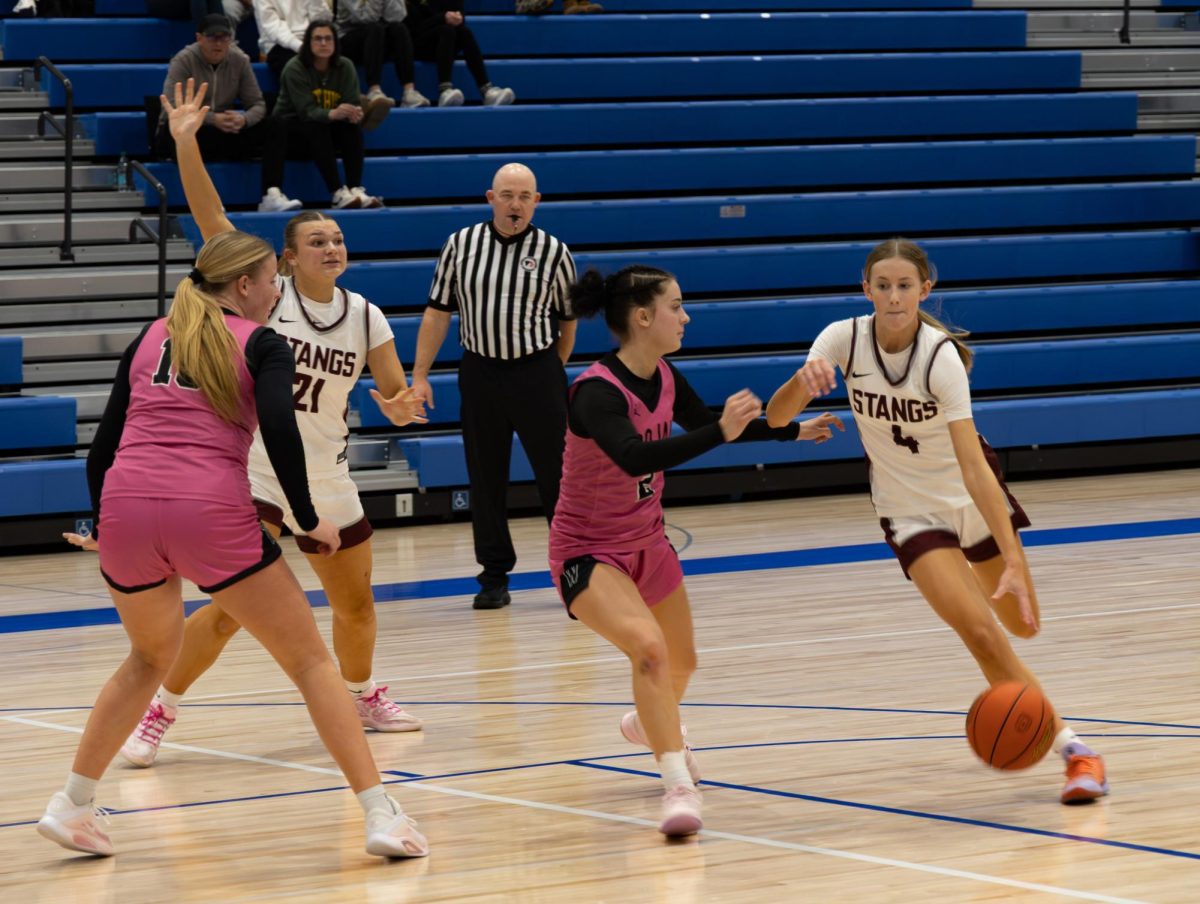Mount Vernon shooting guard Quinn Pershing (No. 4) runs for a two-point attempt during a varsity girls’ basketball game against Iowa City West in Anamosa Saturday, Dec. 6. Iowa City West defeated the Mustangs, 48-37.