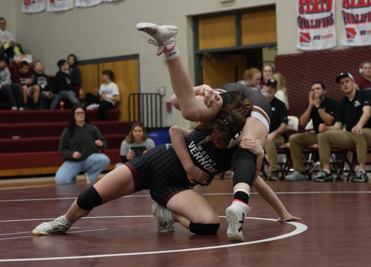 Mount Vernon’s Adeline Whisner gets her 100th pin during Senior Night at the wrestling meet against Solon’s Kendall Koss.