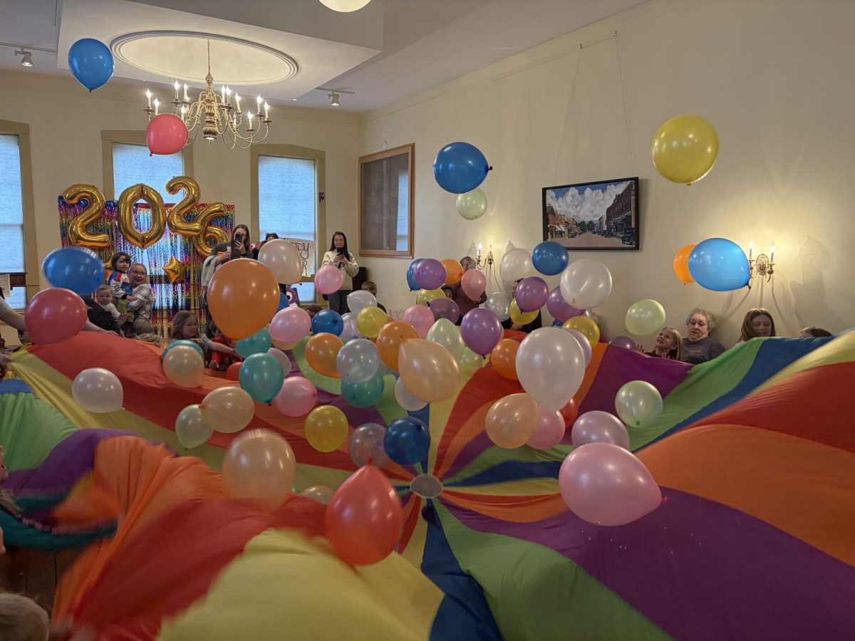 Youth in attendance launch the balloons from the center of a parachute after the count down to ring in the New Yea