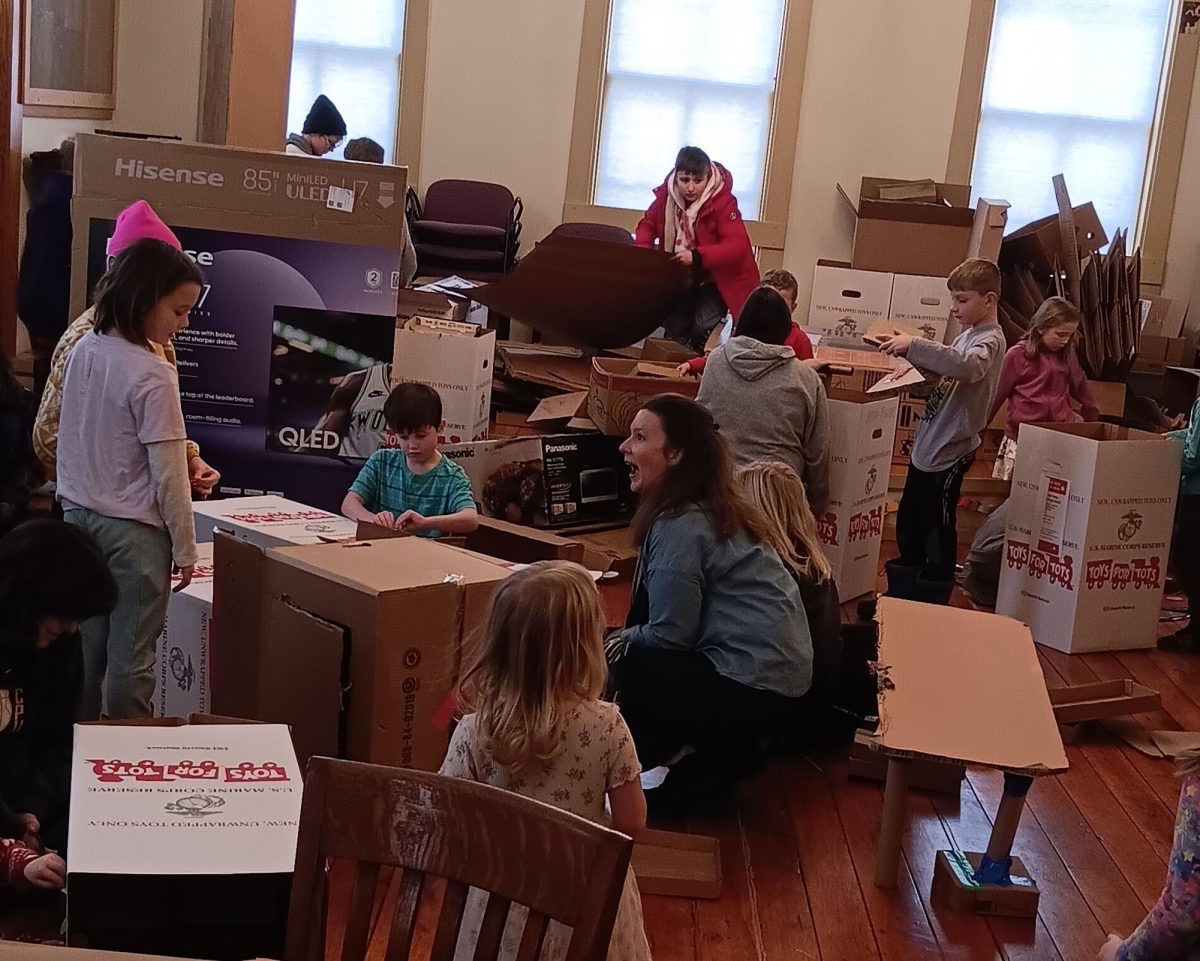 Lisbon Library children’s librarian Meredith Nehring visits with youth about their projects.
