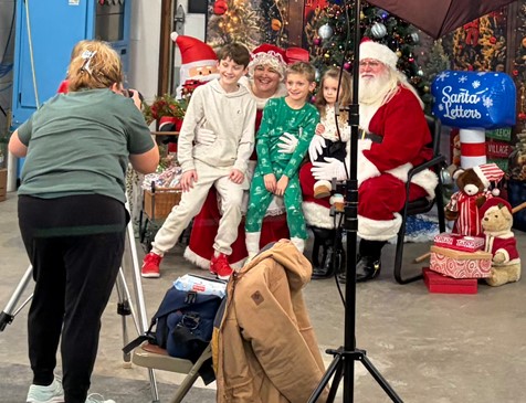 A family gets their photo taken with Santa and Mrs. Claus. Southeast Linn Community Center’s Molly Cart gets the booth set up at the fire station as photos with Santa starts.