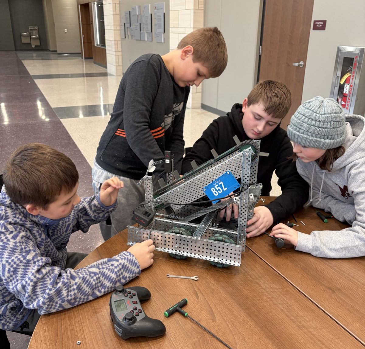 Bowen Bass, Matthew Climek, Korbin Vavricek and Tori Lamb work on their robot.