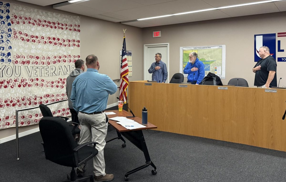 Members of the Lisbon City Council recite the pledge of allegiance before the start of the meeting.