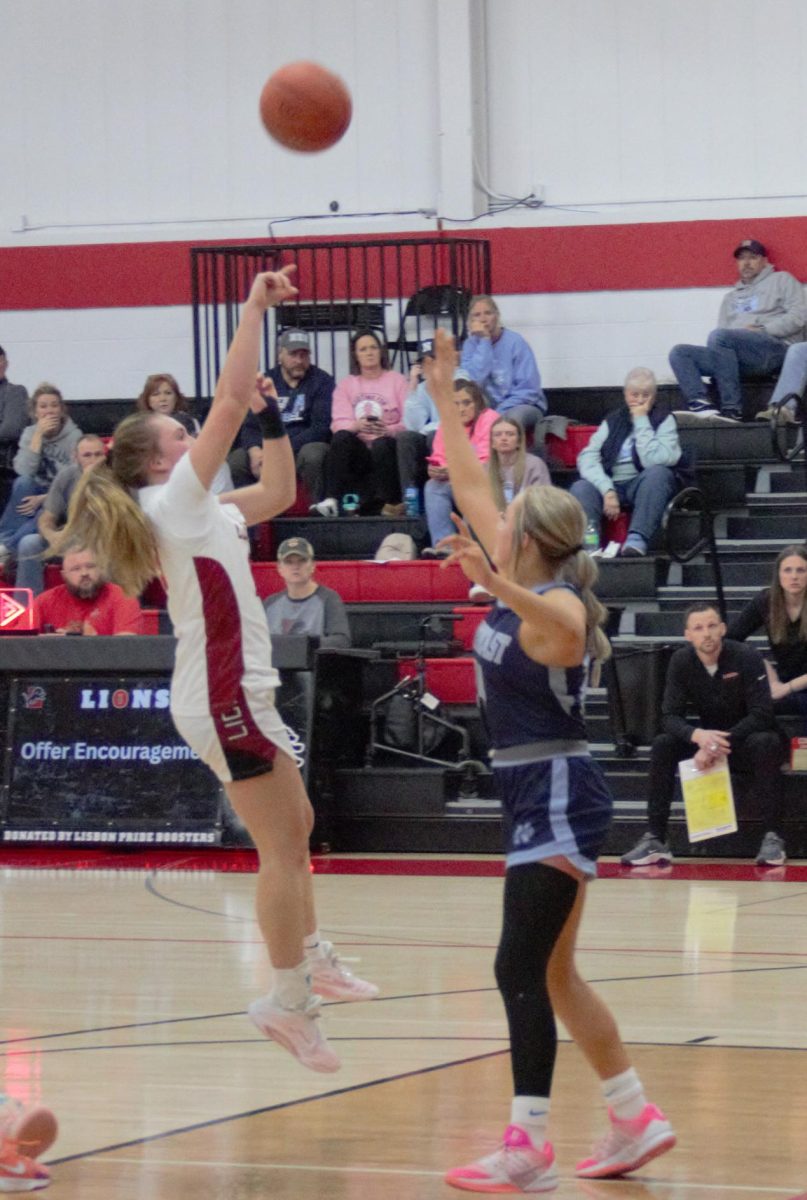 Kyla Kahl (#13) rises for a pull-up jumper directly in the face of the closing defender.