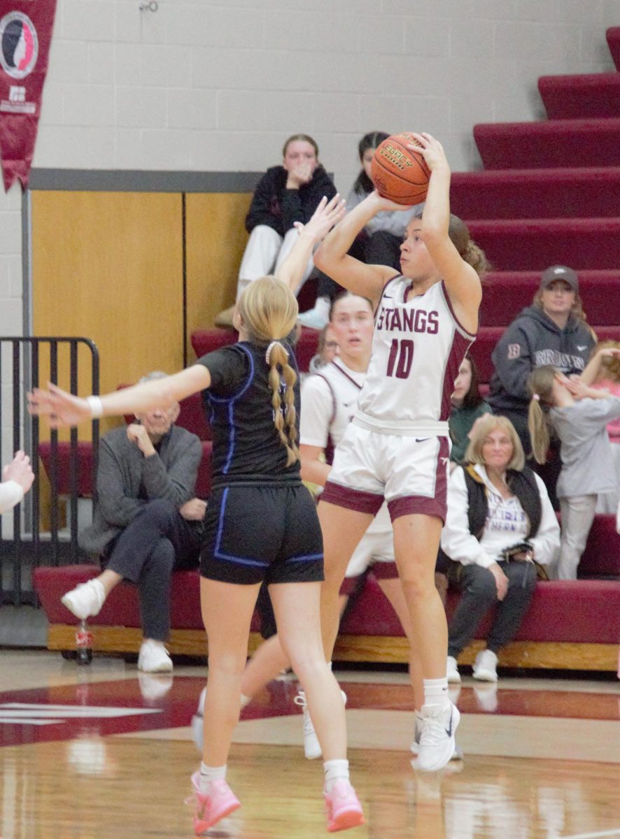 Mount Vernon’s Savanna Wright (#10) sinks a tough, fading mid-range jumper over theoutstretched hand of the defender.