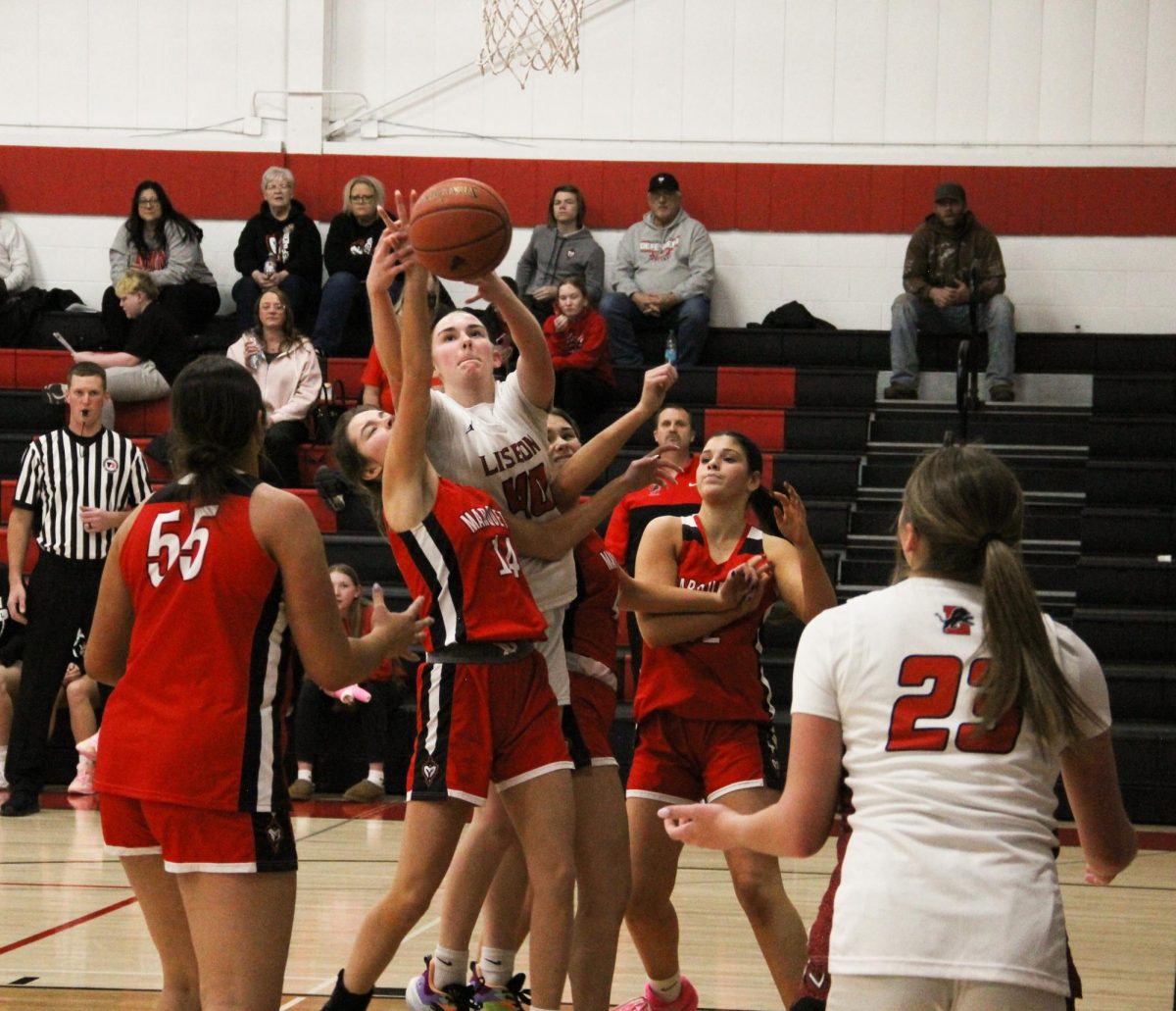 Junior power forward Emma Pleasant (40) extends to grab a rebound while surrounded by Marquette Catholic defenders. (Lance Peterson | For the Mount Vernon-Lisbon Sun)