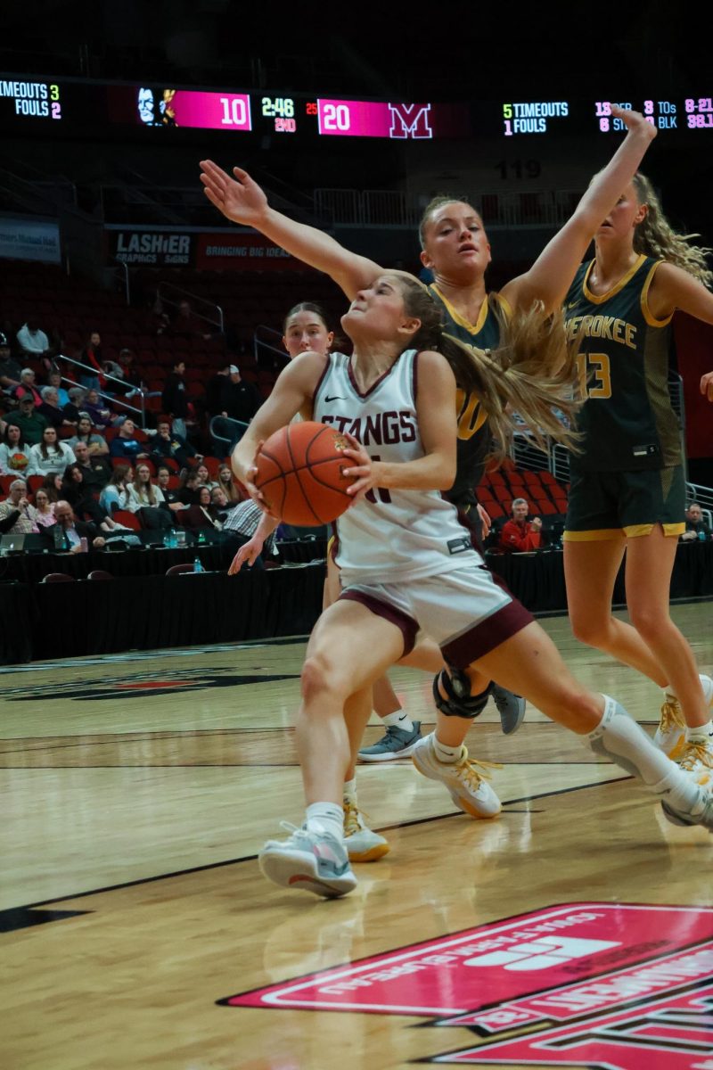 Taylor Franck (#11) drives to the basket through Cherokee defenders during
IGHSAU state tournament on March 2, 2026, at the Casey’s Center