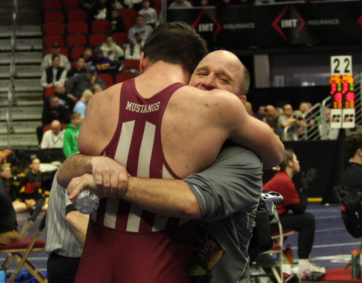 Vance Light hugging Jaxon Anderson at this year’s state wrestling tournament.