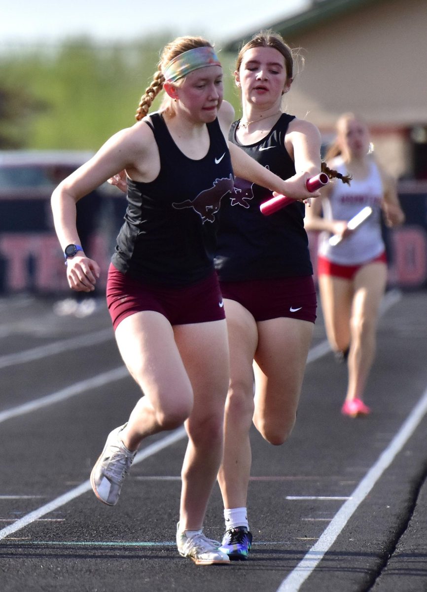 Mount Vernon’s Charlie Stewart passes off to Edith Dawson in the 4x800 relay.