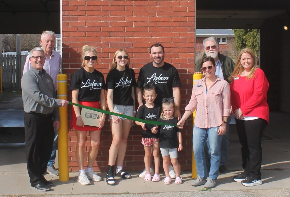 At the ribbon cutting for the Lisbon Car Wash were (from left) Jake Krob (Mount Vernon Bank and Trust), Tom Wieseler (Mount Vernon mayor), Alex Pence, Harpr Pence, Brandon Pence, Benelli Pence, and Lakelyn Pence (owners of the Lisbon Car Wash), Jessie Thurn (director Mount Vernon-Lisbon Community Development Group), John Bardsley (Lisbon city council) and Brenda Langenberg (Hills Bank and Trust).