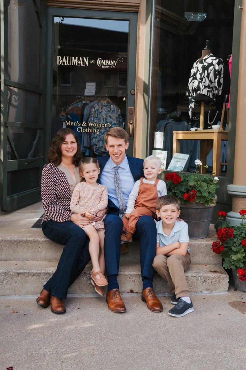 Olivia and Josh Randall and their children in front of Bauman’s.