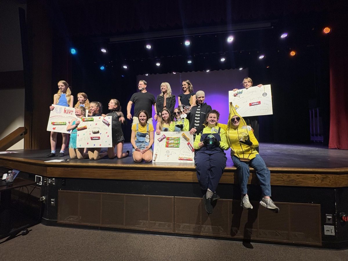 Participants and judges pose with their awards following the lip sync competition, celebrating their performances and fundraiser success.