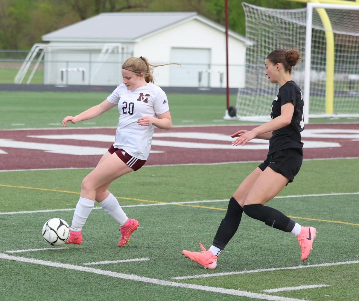 Mount Vernon’s Avery Miller (No. 20) looks to advance the ball down the field against an Independence defender Tuesday, May 5.