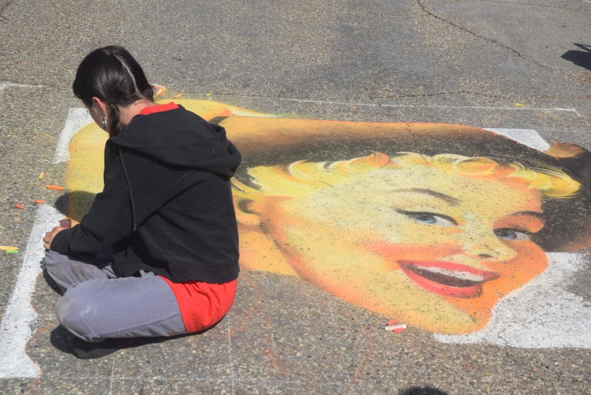 Featured artist Autumn Zaehringer works on her featured artist piece at this year’s Chalk the Walk festival.