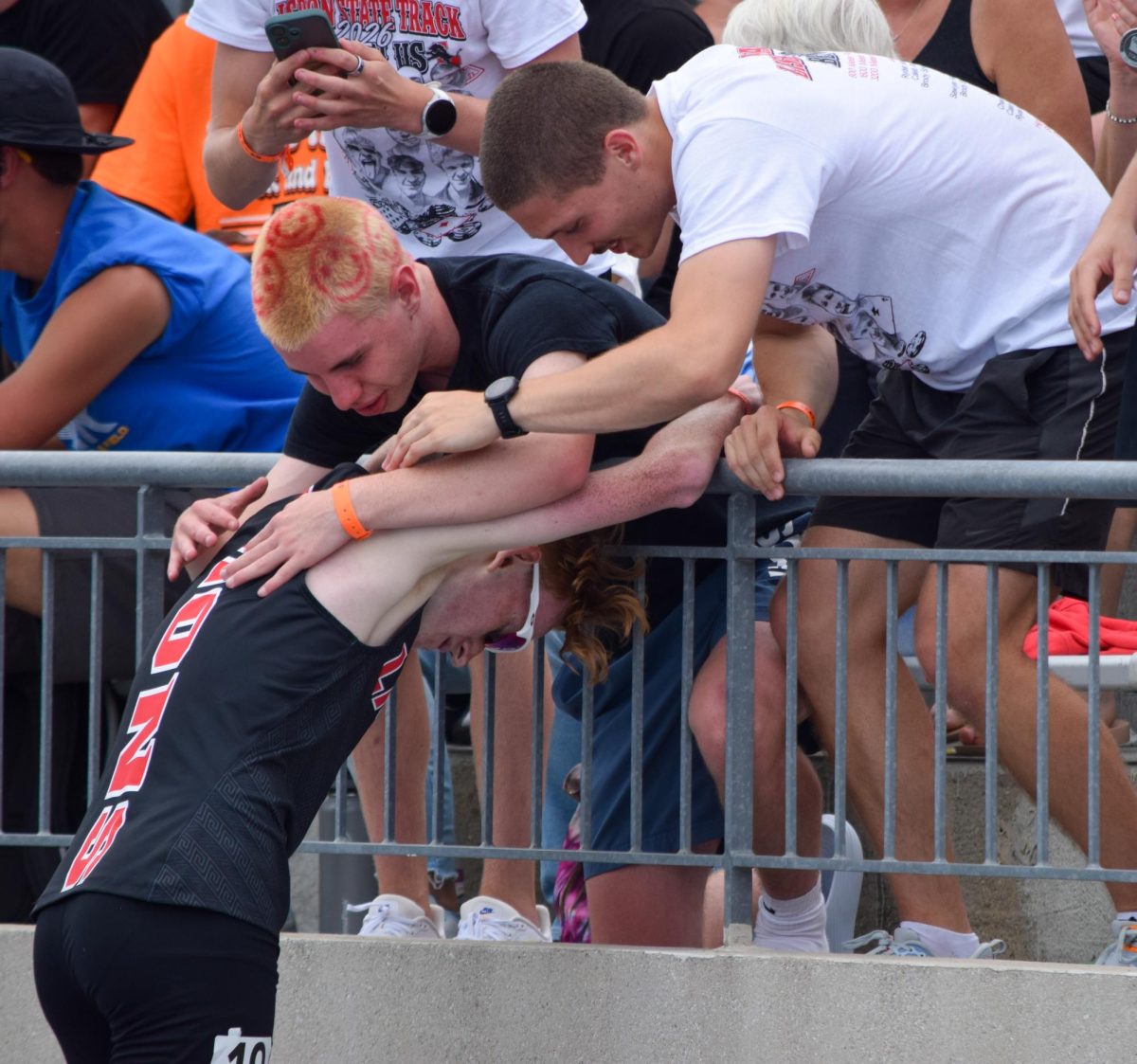 Lisbon’s Sawyer Feldman is embraced by his teammates after competing in the 1600 meter
final at the Iowa State Track and Field Championships in Des Moines on Saturday, May 23.