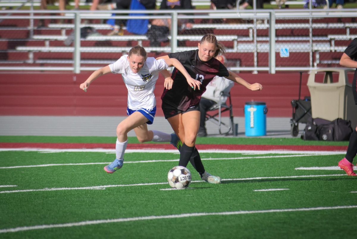 Mount Vernon’s Kaia Swaim (No. 13) moves the ball downfield as a Benton Bobcat defender tries to snag it. (Anne Wagner contributed photo)