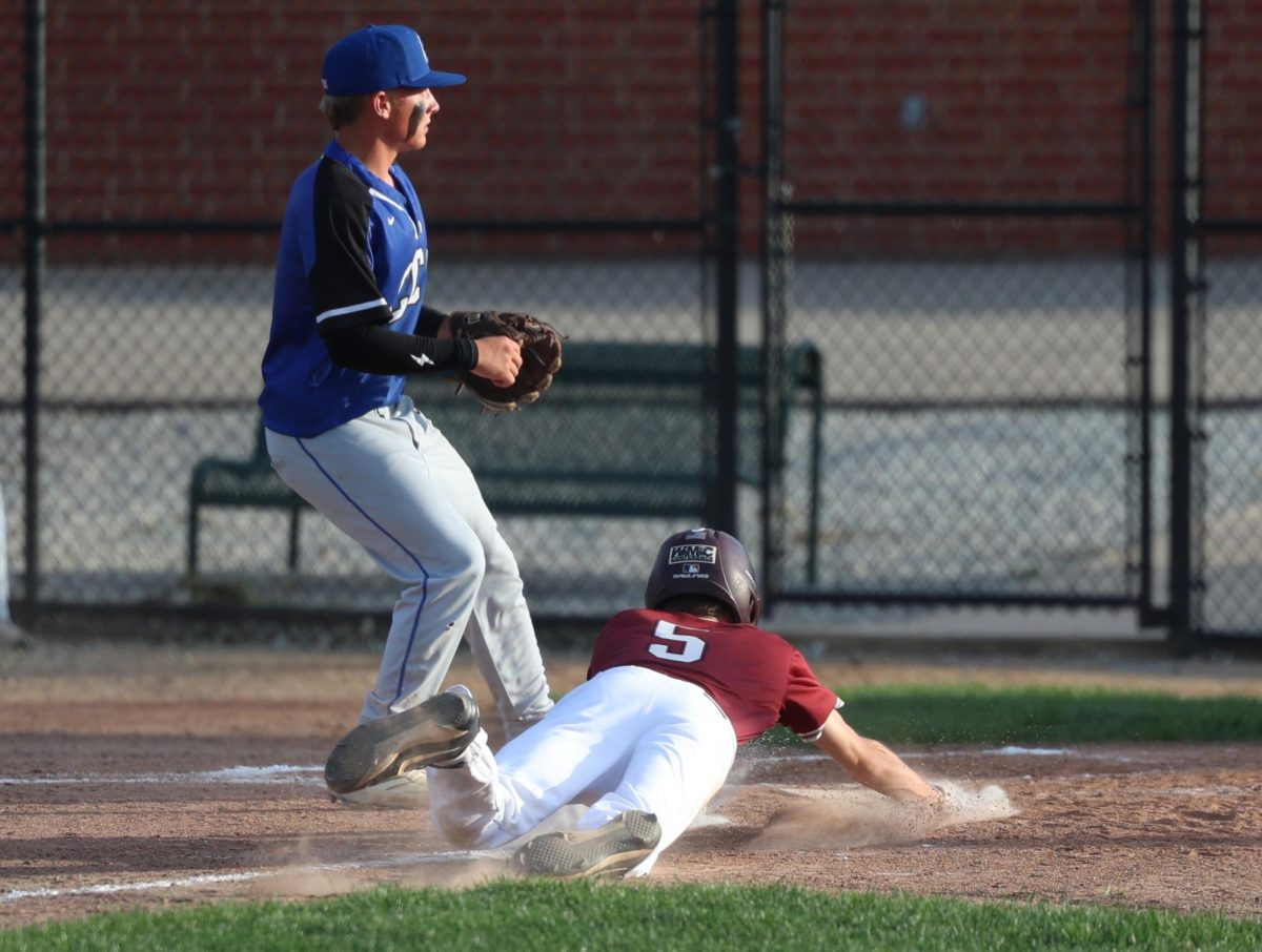 Mount Vernon’s Hudsyn Reyhons slides into home safely.