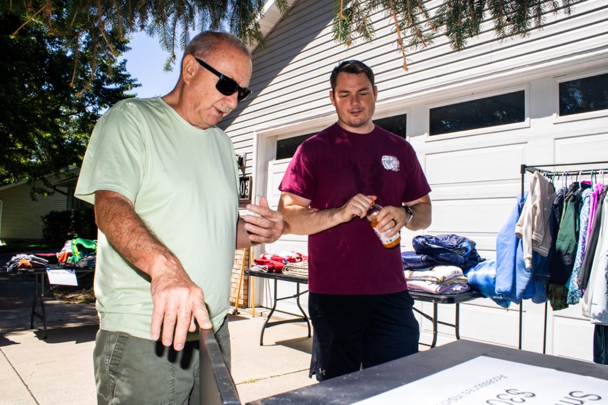 Paul Berry and Matt Hoffert inspect a smoker while setting up for their family’s garage sale in Mount Vernon on Friday, June 19, 2026. This is the Hoffert family’s third consecutive year hosting a garage sail.