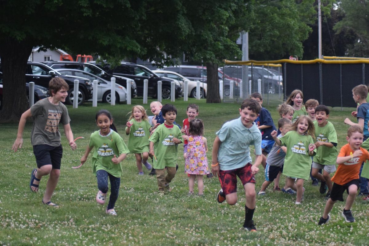 Children run from Mr. Crocodile at the Lisbon Public Library's Summer Reading Kickoff Event in Lisbon City Park on Thursday, June 4, 2026
