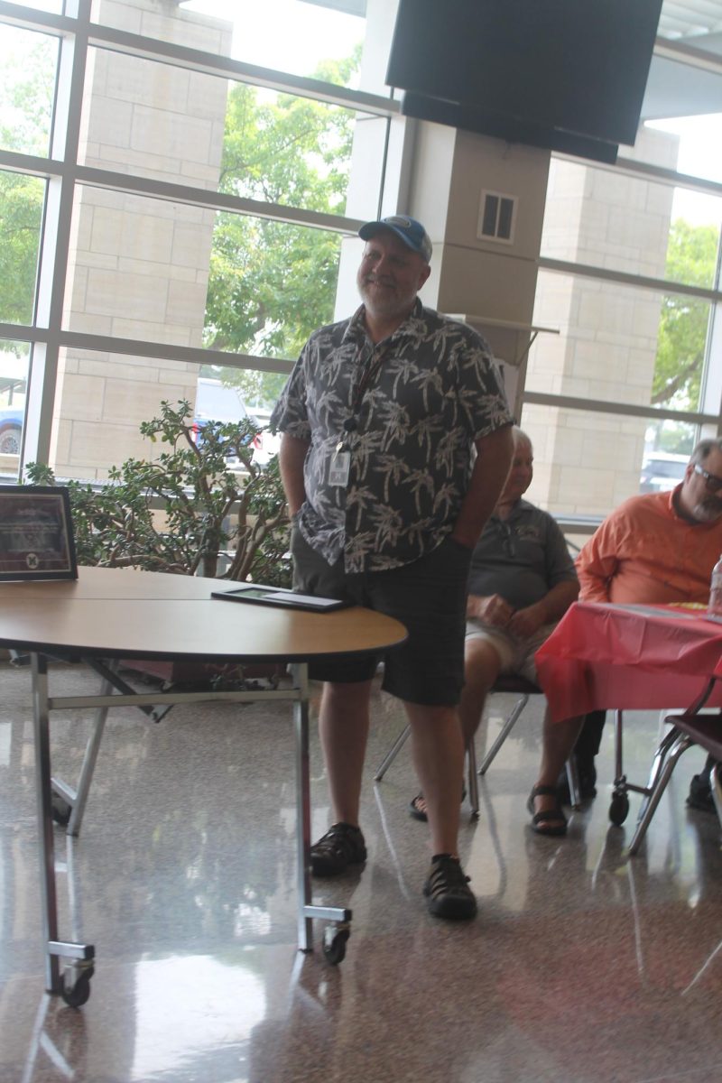 Tom Wilkinson listens to speaker Ryan Whitman talk about Wilkinson’s impact on Whitman’s life at the retirement event Thursday, May 28.