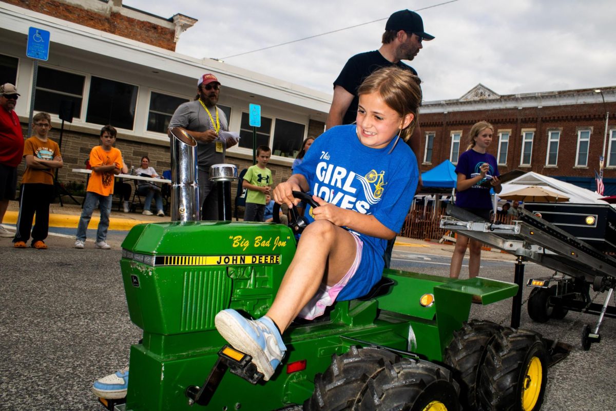  Scarlett Farrington pedals during the kids’ pedal tractor pull competition of the first annual revival of Pork Center Days in Mechanicsville Friday, June 26. 