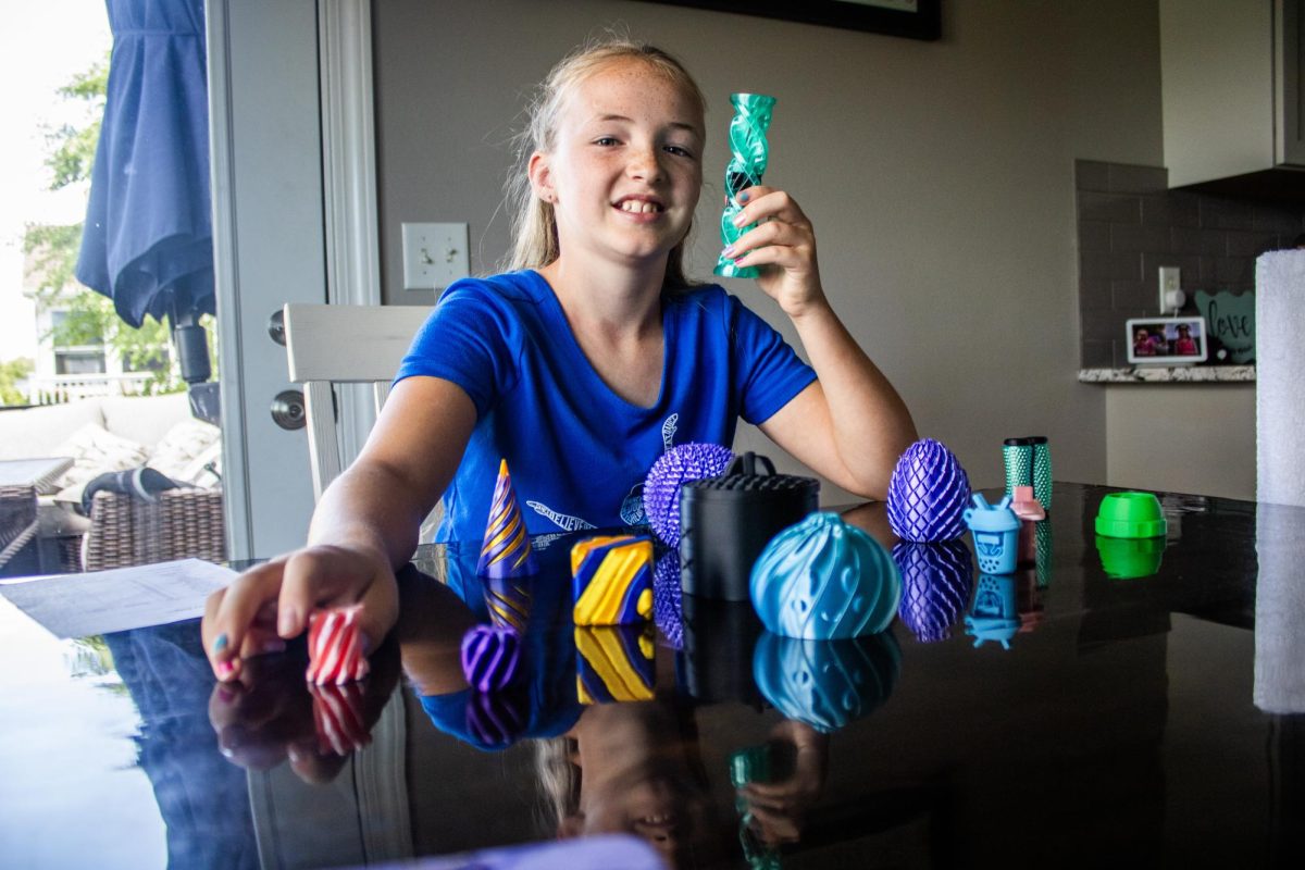 Henley Neff, 10, poses for a portrait with her 3D printed fidget toys inside her home in Mount Vernon Friday, July 3. Henley and her mom have 3D printed over 80 fidget toys to order. Recently, the two have been contacting local retailers to help sell additional stock.
