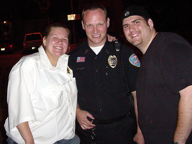 Todd Gehrke (center), clad in uniform his rookie year, smiles with two of the students he worked with at Cornell College.