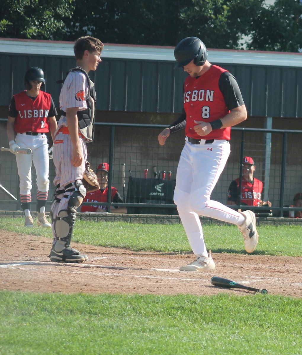 Lisbon’s Ian Whittenbaugh crosses home plate for a point against Easton Valley.