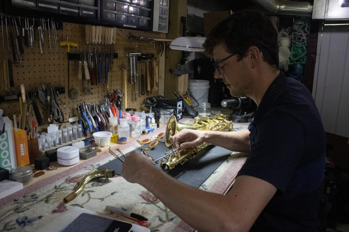 Mike Livingston repairs a saxophone with precision at the Mount Vernon Repair Shop June 30. Livingston has operated the repair shop in Mount Vernon for the past two years.