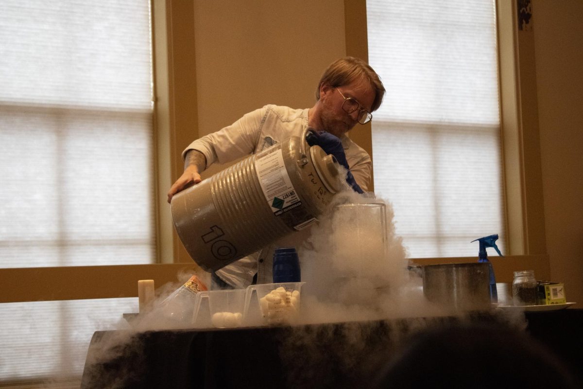 Jerry Walton pours liquid nitrogen into a beaker as he sets up for the next experiment at Lisbon Heritage Hall on July 9, 2026.